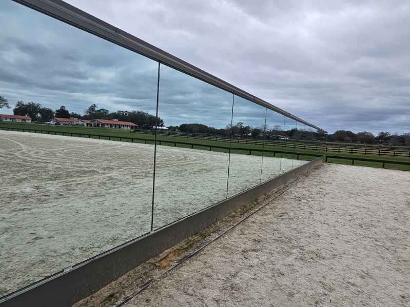 Seamless outdoor dressage arena mirror wall reflecting the arena and Florida sky